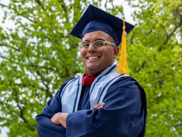 Senior portrait of young latino grad in cap and gown
