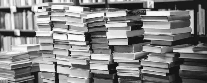 Books stacked up depicting the title of Books