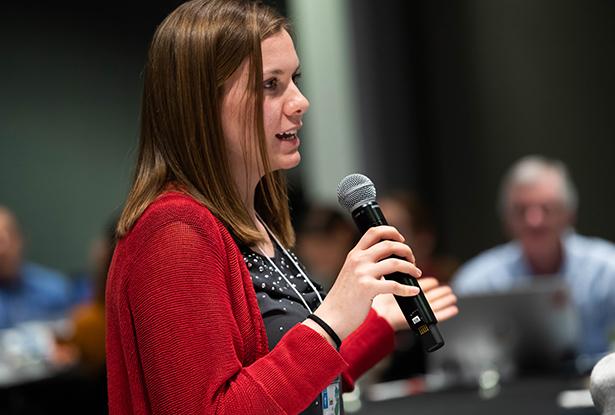 Sarah Mack speaking into a mic