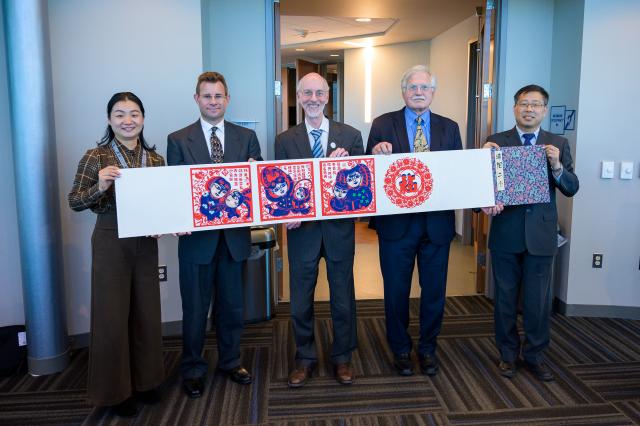 Several Educators involved in Training Held at NAAB Holding a Sign