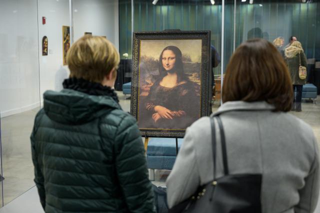 Women admire the reproduction of the Mona Lisa at the da Vinci exhibit at Kean