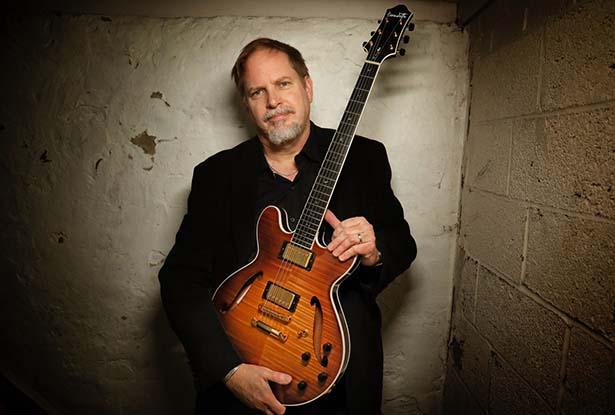 Musician Dave Stryker with a guitar