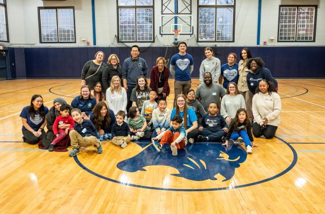 Group photo of occupational therapy and recreational therapy students with SONJ kids in the East Campus gym