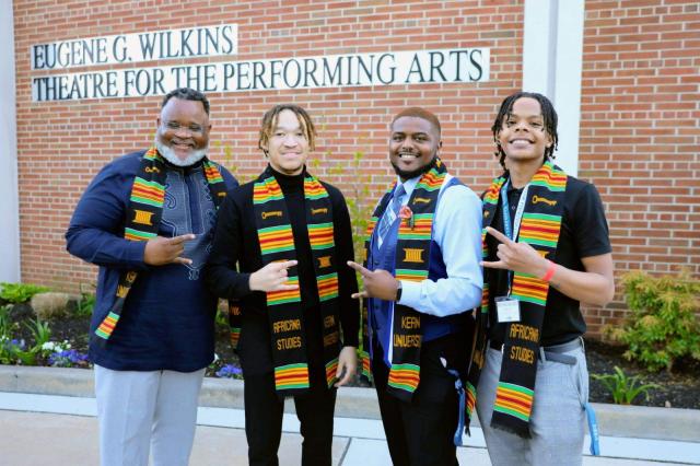 President Repollet poses with students at African Heritage Graduation