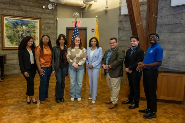 Acting Governor Tahesha Way poses with seven Kean University students.