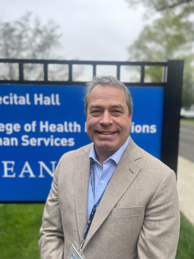 Headshot of David Stellmach in front of Kean University's East Campus