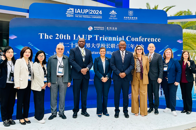 A group of Kean University leaders, with President Repollet at the center, pose outside the 20th IAUP Conference in China.