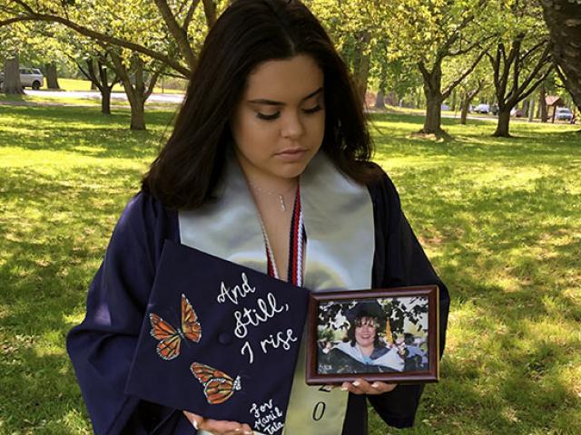 Daniela Derius Rodriguez, Kean Class of 2020, poses with a photo of her mother.
