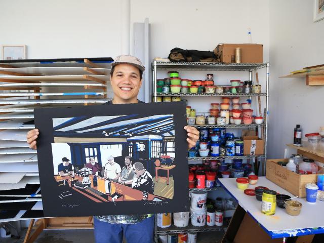Artist Ricardo Roig displays a piece of his art in his studio
