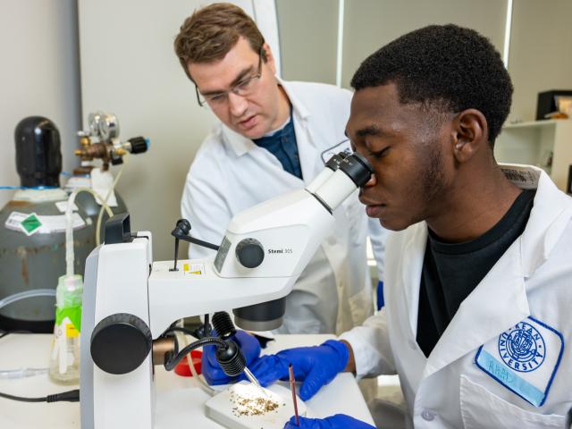 A Kean student researcher and a faculty member working in the lab