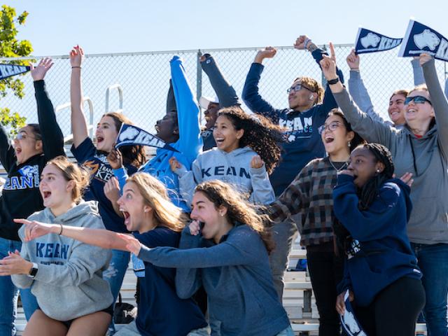 Kean students enjoy the big game, cheering from the stands at Kean's homecoming