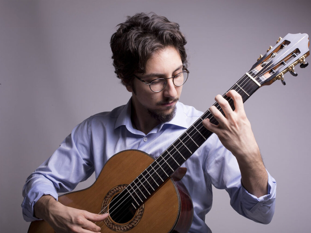 Musician and composer Celil Refik Kaya plays guitar.