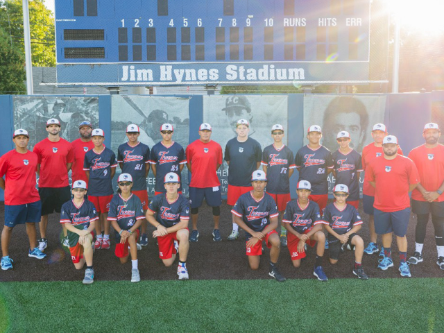 Rey Cruz poses with the coaches and players of the Troopers.