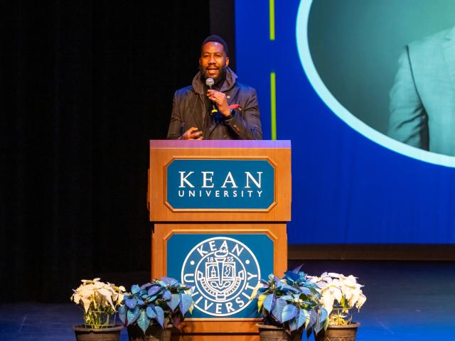 Ndaba Mandela speaks at a podium at Kean University