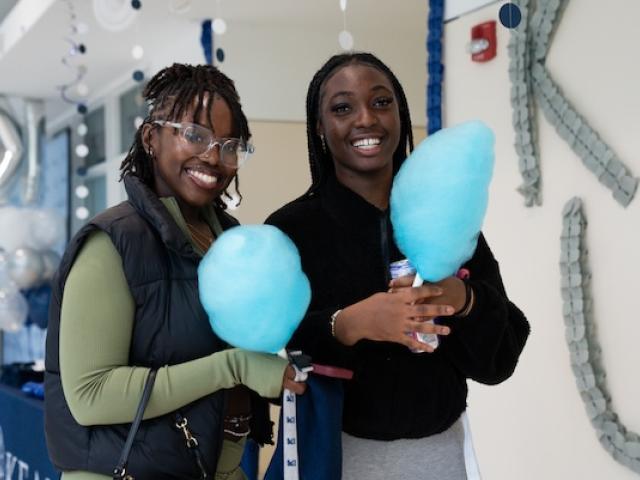 Kean students hold cotton candy at a campus event