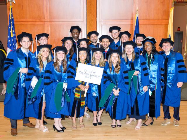 Doctor of Physical Therapy Graduates at Kean University in large group in regalia