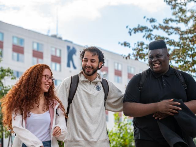 Kean students laugh outside Upperclassmen Residence Hall 