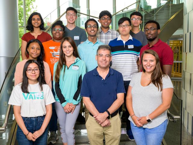 GSSRP students standing on the main staircase of the STEM building