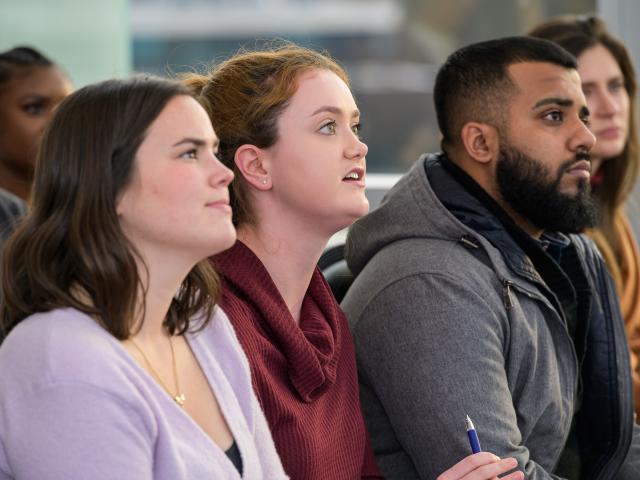 Students listen attentively to lecturer David Axelrod, a political expert.