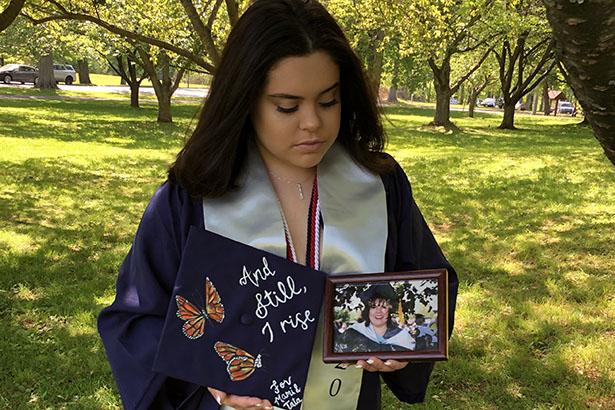 Daniela Derius Rodriguez, Kean Class of 2020, poses with a photo of her mother.