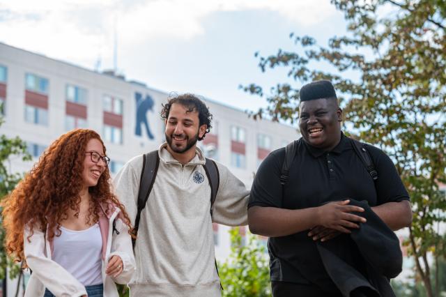 Kean students laugh outside Upperclassmen Residence Hall 