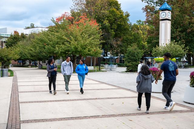 Kean students walk past the clock tower