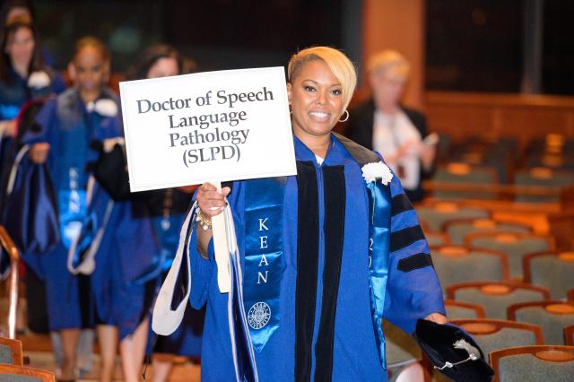 A procession of doctoral students takes part in Kean Commencement in 2019.