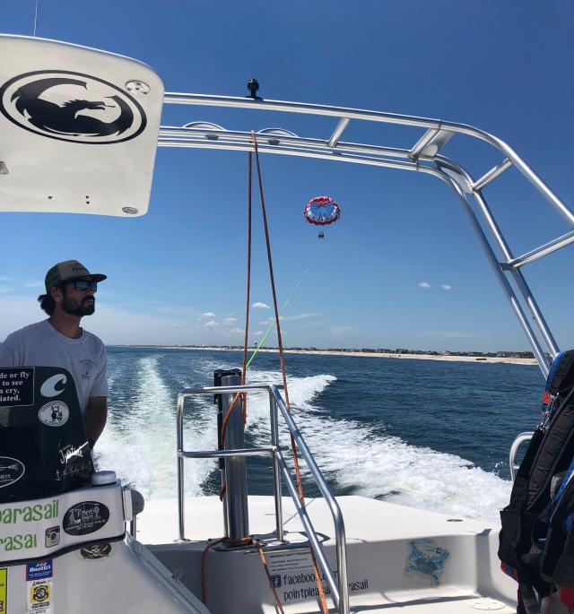 Christopher Titmas drives his boat with a parasailer