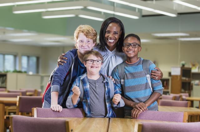 LDTC teacher pictured with three children with special needs