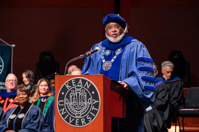 President in blue regalia at the podium