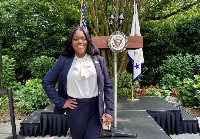 Kean alumna Nekeisha Blandin poses in front of the podium at the vice president's house, during the Dia De Las Madres event