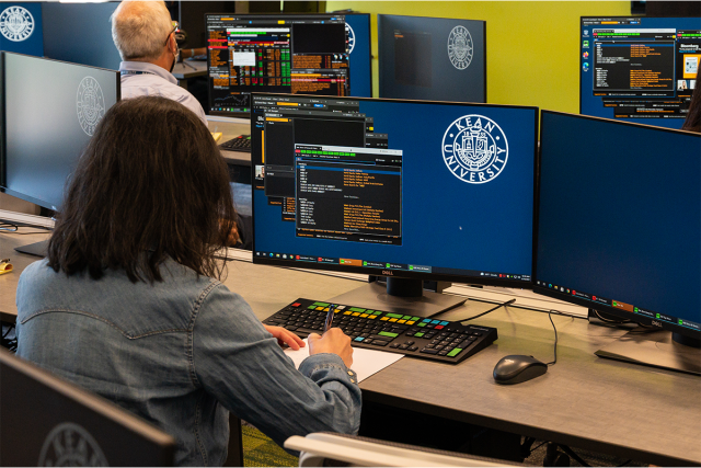 Students work on Bloomberg terminals in Kean's College of Business and Public Management