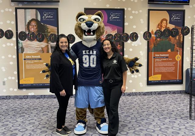 The Kean Cougar joins educators in the lobby of Enlow Auditorium