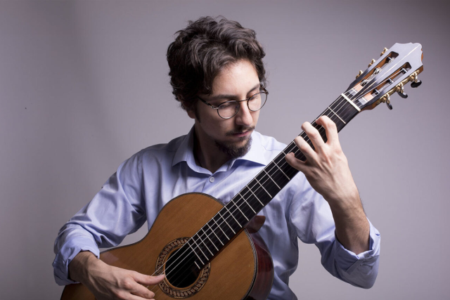 Musician and composer Celil Refik Kaya plays guitar.