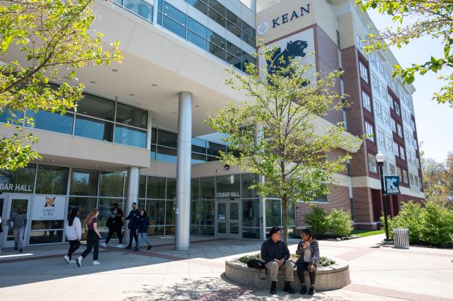 Campus life at Kean University. Students pictured outside Cougar Hall.