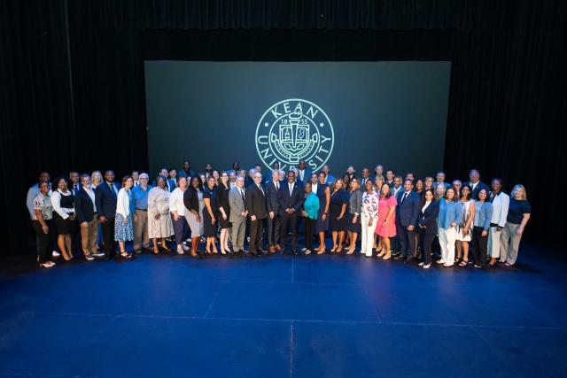 Kean leaders pose for a group shot on the stage