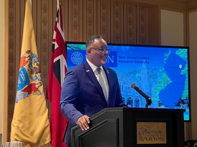 Kean President Lamont Repollet speaking at a podium