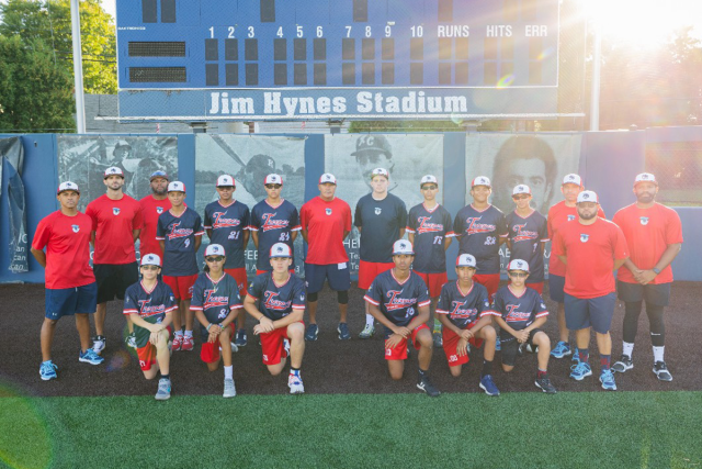 Rey Cruz poses with the coaches and players of the Troopers.