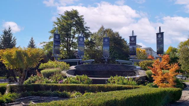 The fountain on Kean's campus, with flags displaying names of the Kean campuses