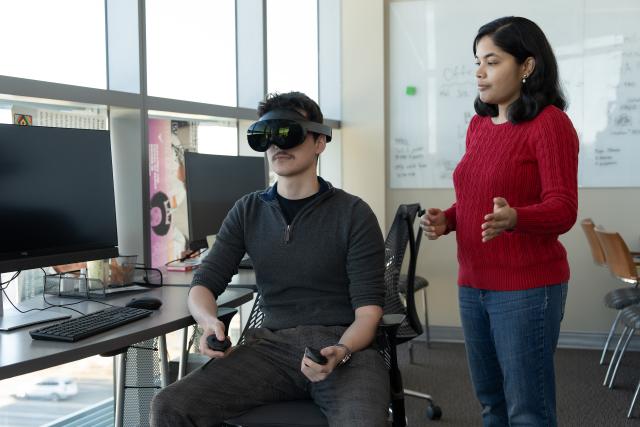 Assistant Professor Lakshmi Subramanian, Ph.D. works with a student researcher