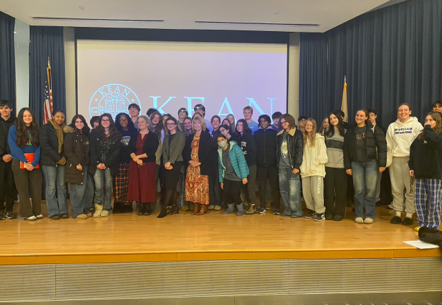 High schooler attendees pose with speakers on stage