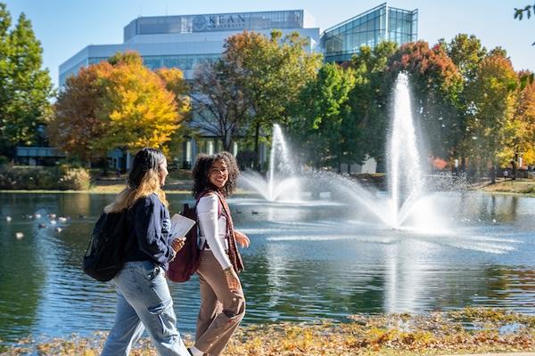 Kean students walk near the STEM building fountain 